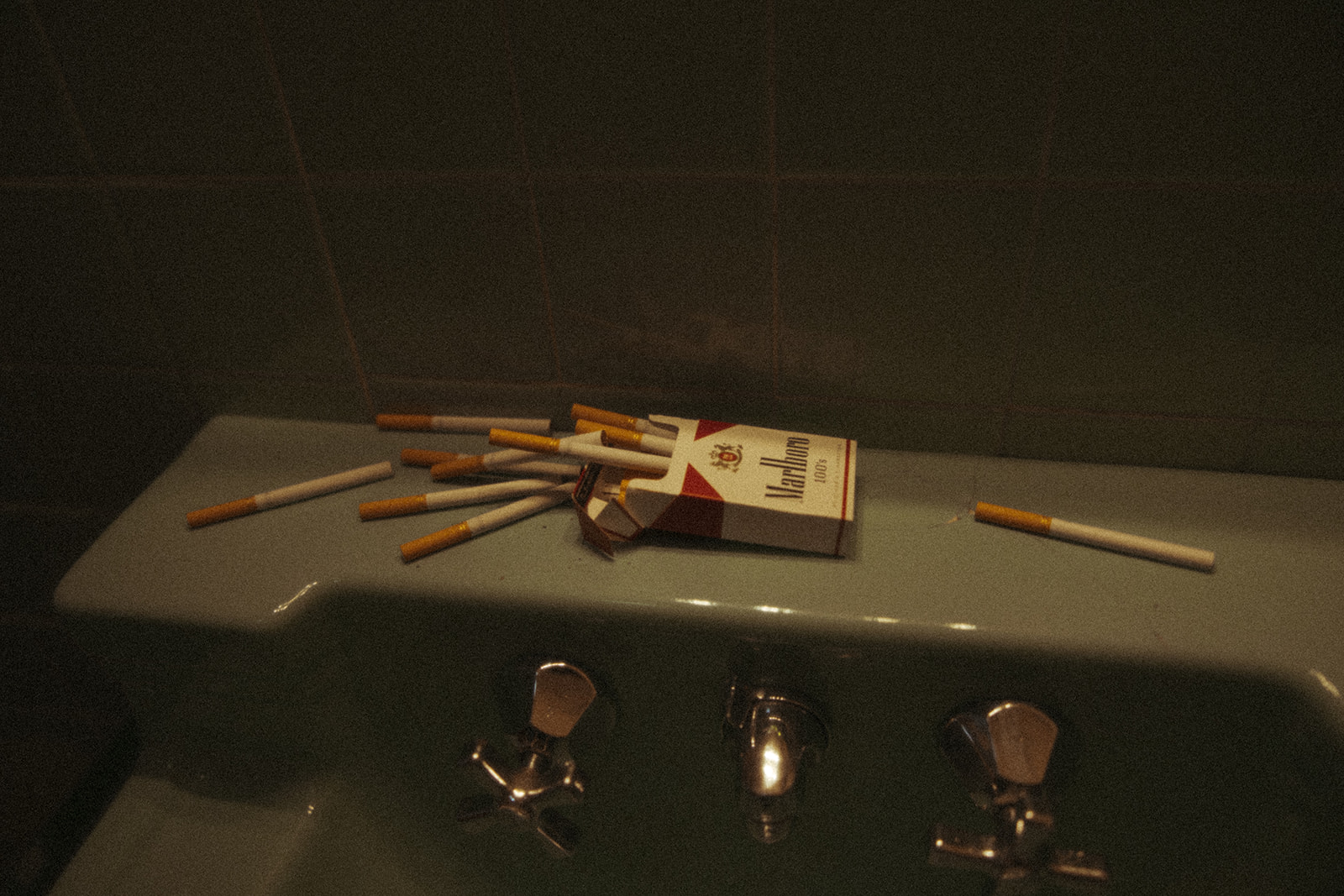 Marlboro cigarettes' on a bathroom sink