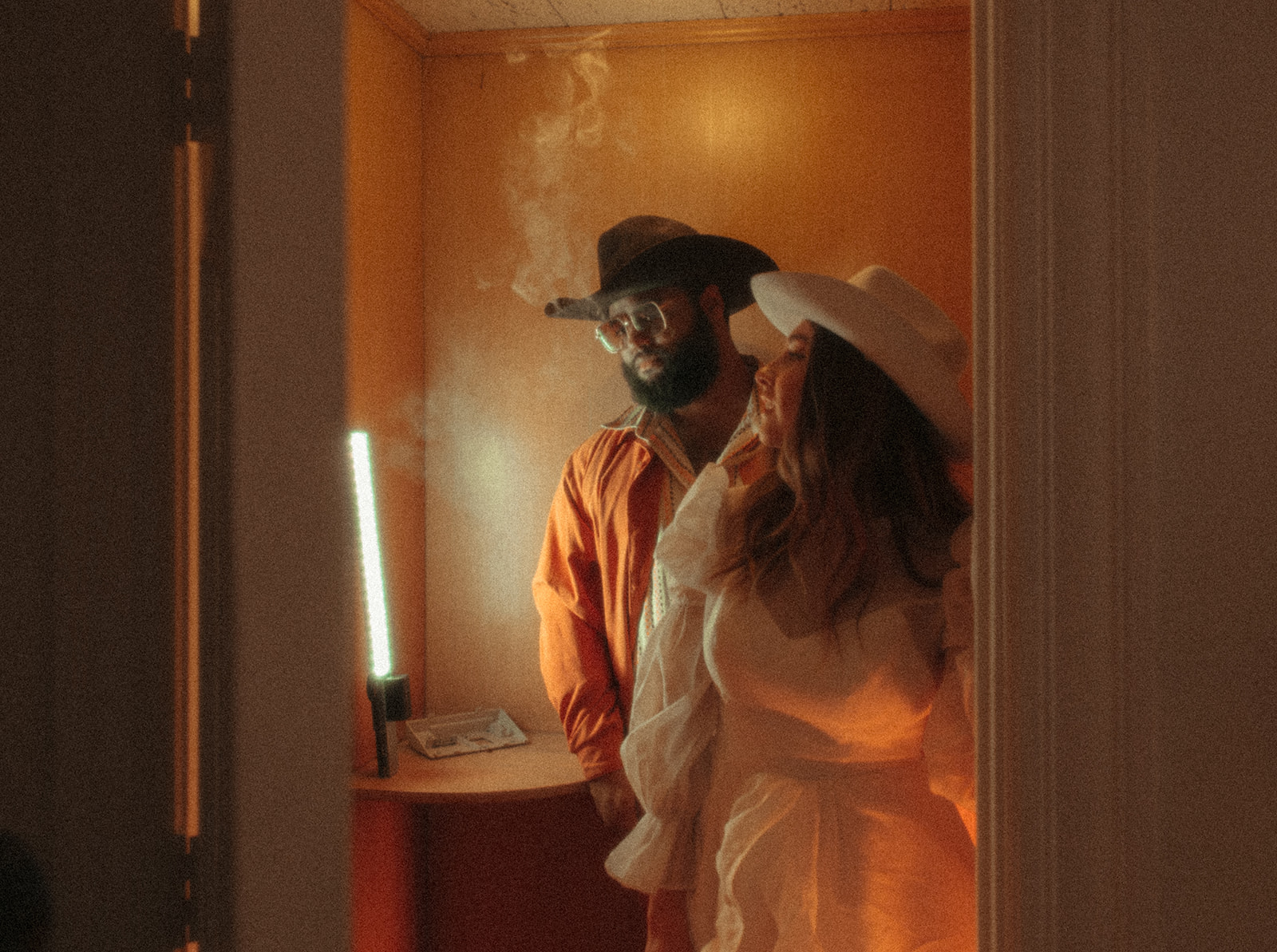 Man and woman smoking in a bathroom
