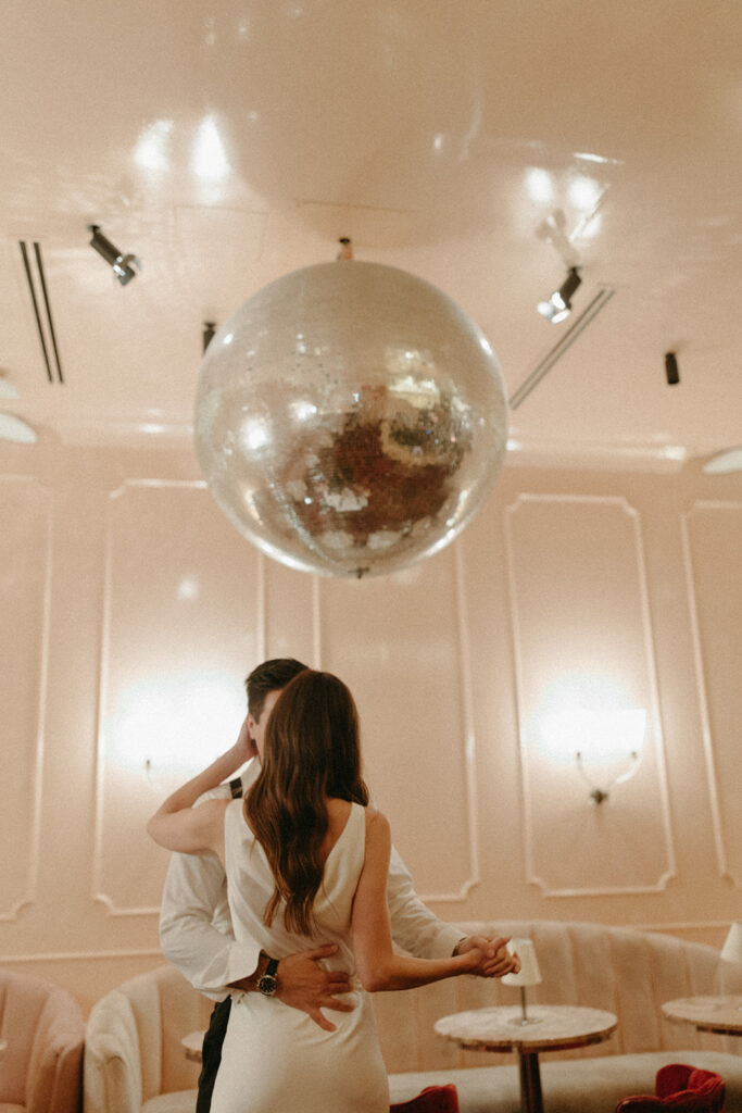 Man and woman dancing under a disco ball