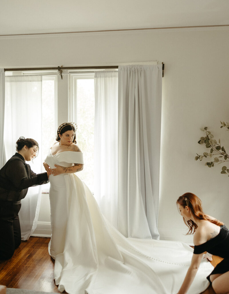 Woman getting into her wedding dress