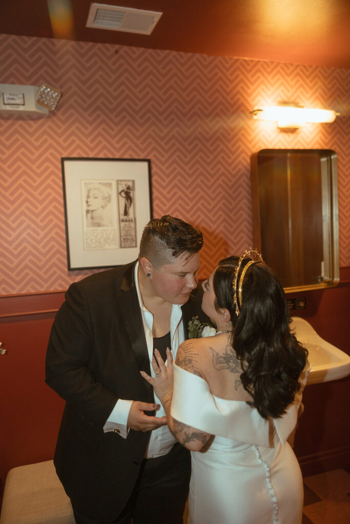 Couple posing for portraits at Willis Show Bar after their Detroit wedding