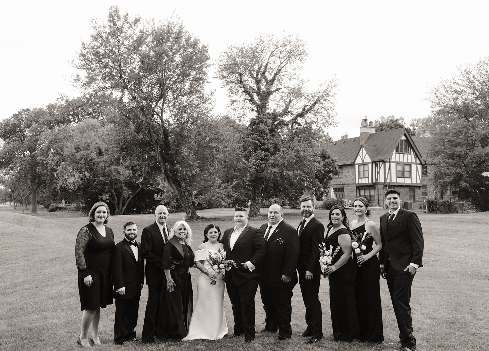 Couple posing for photos with their wedding party 