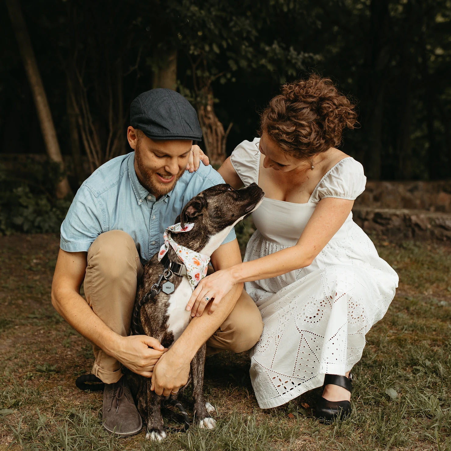 Couple posing for engagement photos with their dog
