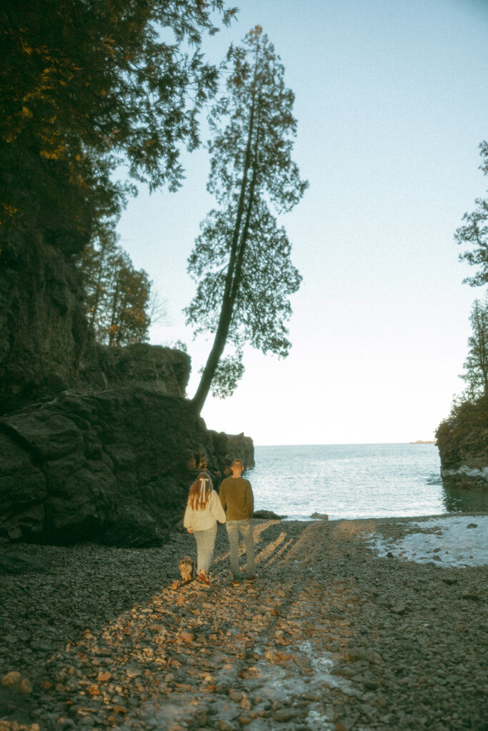 Couple walking along Black Rock for their Marquette Michigan engagement photos