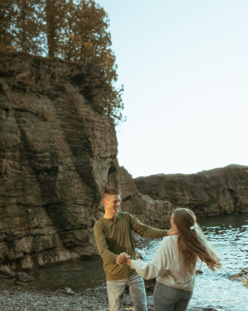 Couple being playful during their Marquette Michigan engagement photos