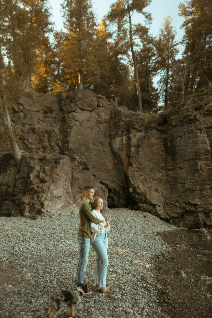 Couple admiring Lake Superior during their Marquette Michigan engagement photos