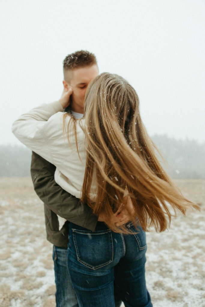 Snowy Marquette Michigan engagement photos in an open field