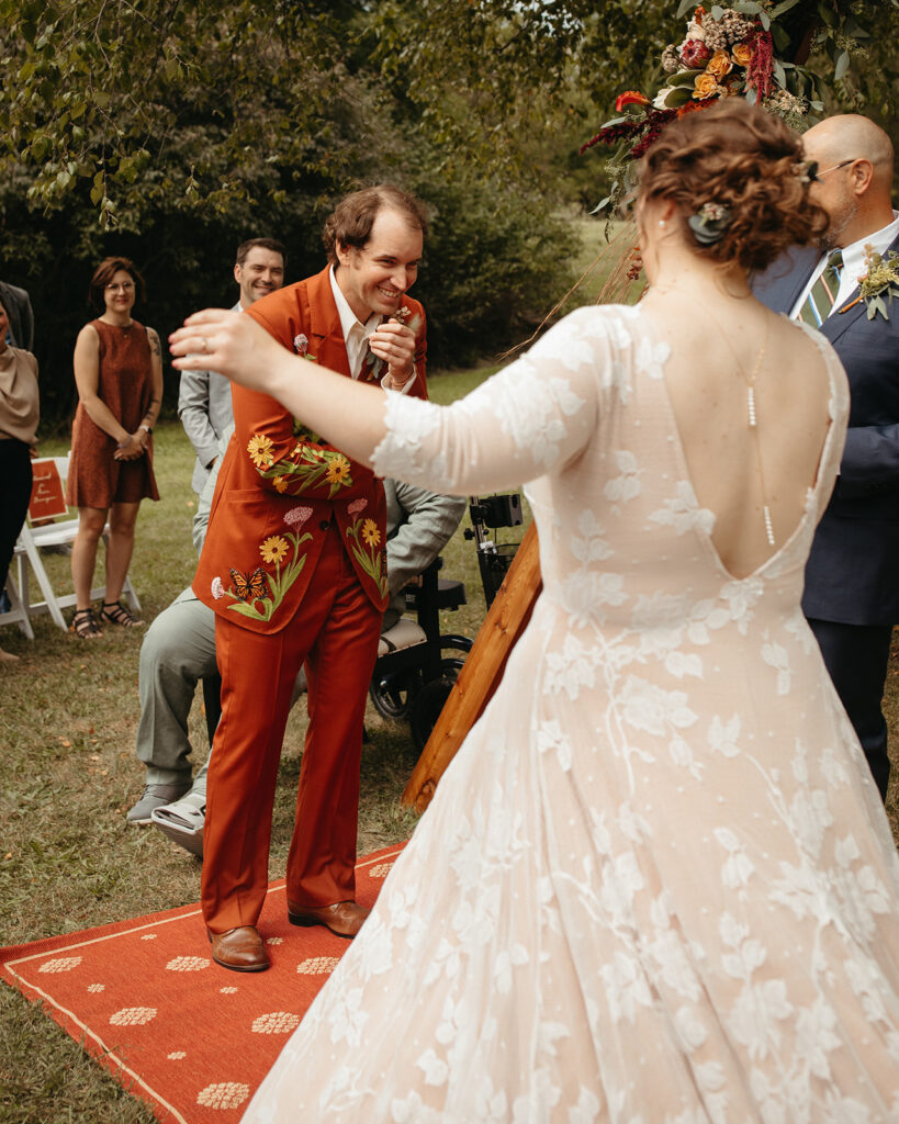 Emotional groom seeing his bride for the first time during their Michigan wedding