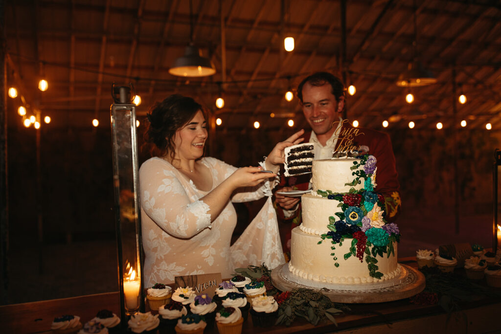 Bride and groom cutting into their wedding cake
