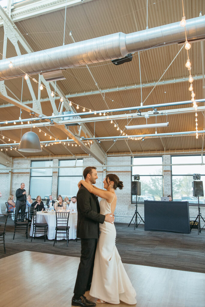 Bride and grooms first dance during their Baker Lofts Holland MI wedding reception