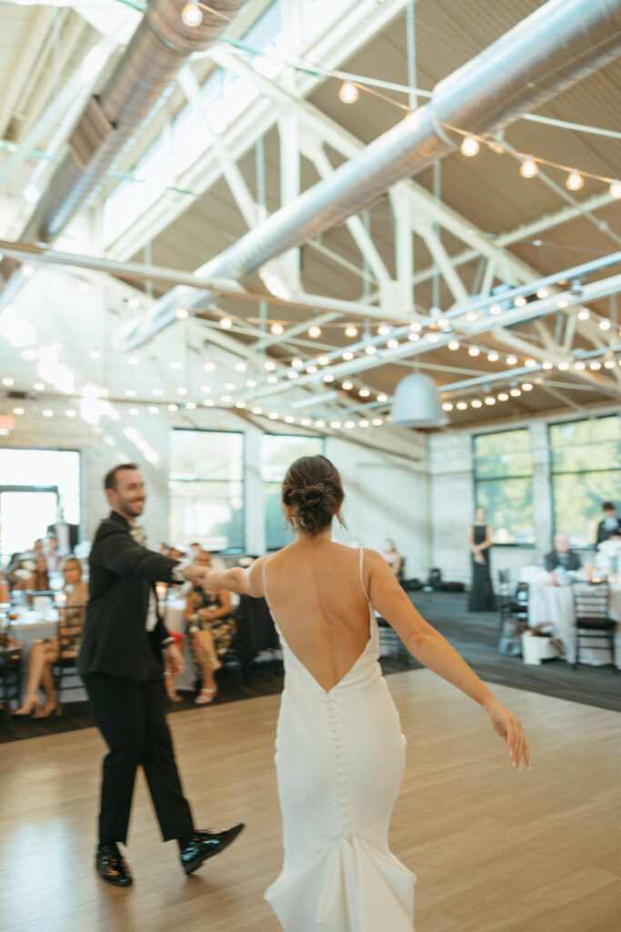 Bride and grooms first dance during their Baker Lofts Holland MI wedding reception