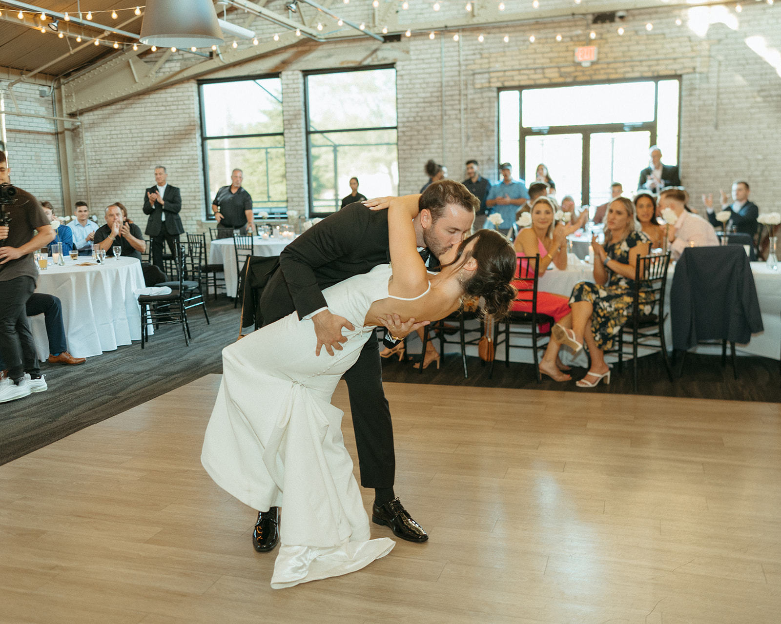 Bride and grooms first dance during their Baker Lofts Holland MI wedding reception