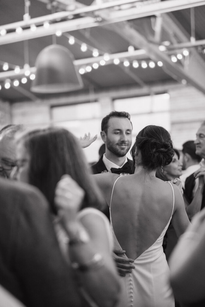 Black and white photo of a bride and groom dancing during their Baker Lofts Holland MI wedding reception