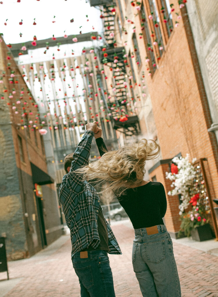 Couples fun downtown Detroit engagement photos in The Belt alley