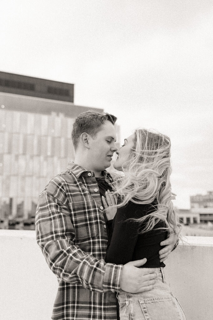 Black and white photo of a couple about to kiss for their downtown Detroit engagement photos up on Z Lot