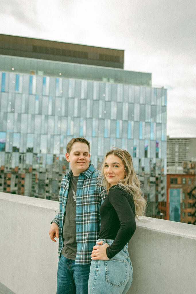 Couple up on a parking garage rooftop for their downtown Detroit engagement photos at Z Lot