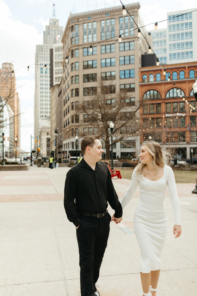 Couple walking in downtown Detroit for their engagement photos