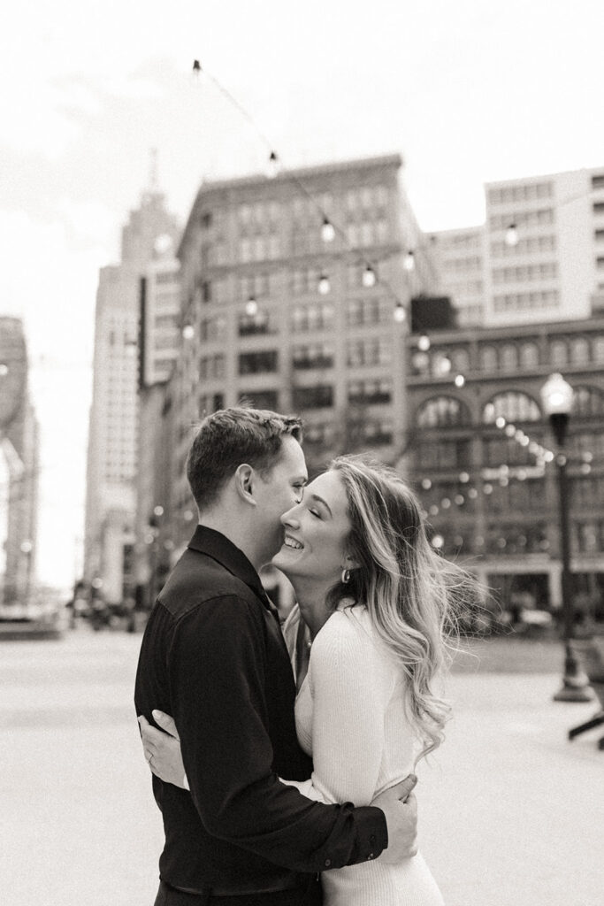 Black and white photo of a couple  hugging during their downtown Detroit engagement photos