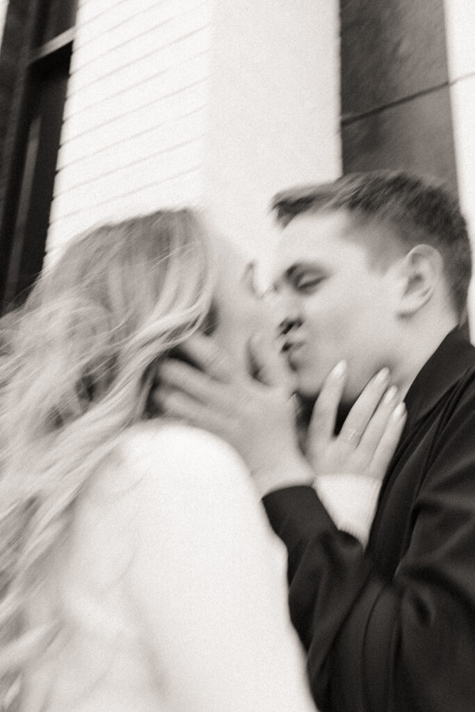 Blurry black and white photo of a couple kissing