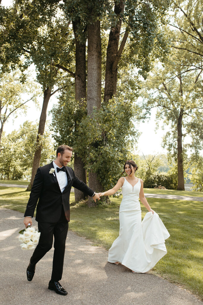 Bride and groom holding hands and walking after their Grand Rapids wedding ceremony