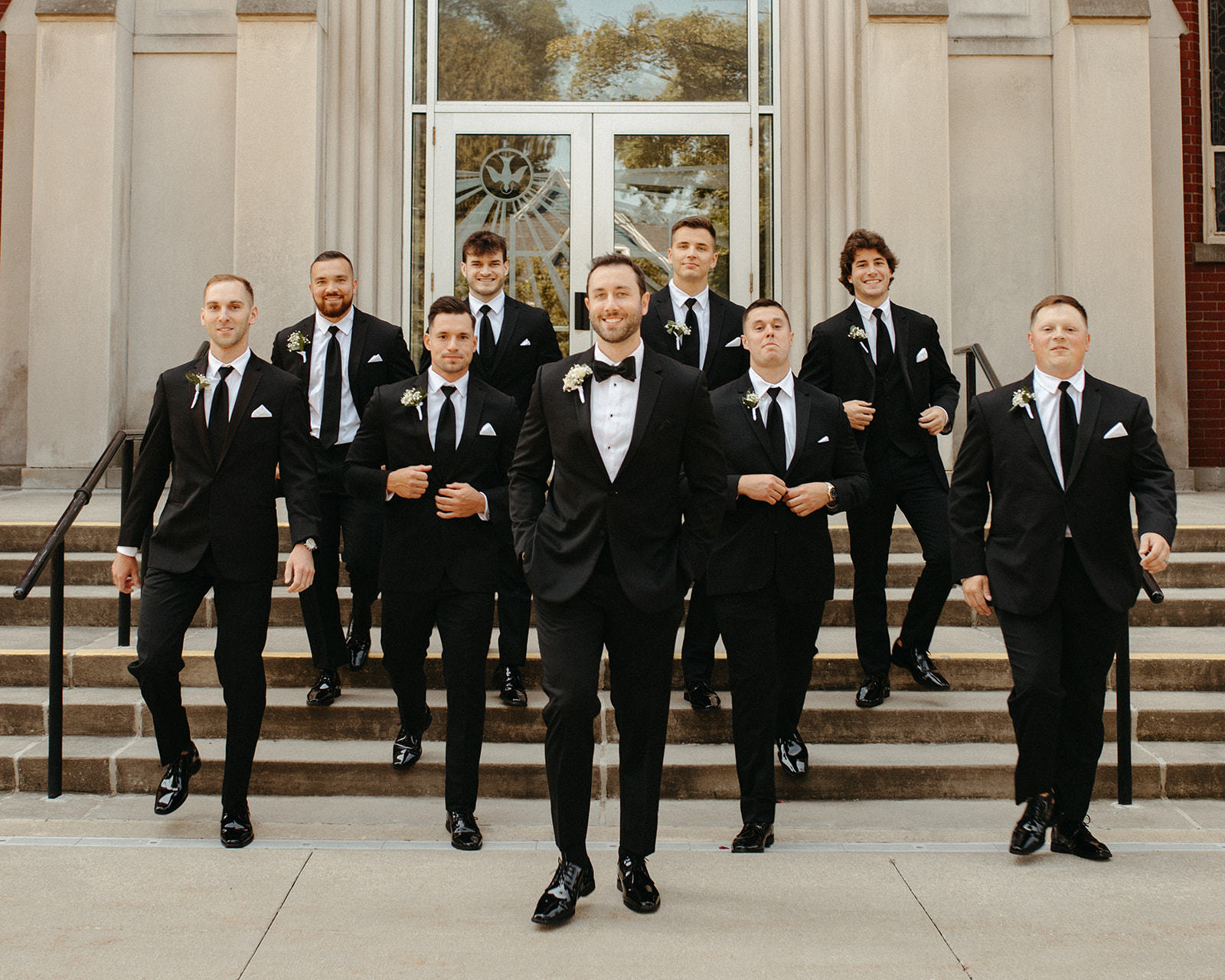 Groom and groomsmen portraits in front of a church for a Grand Rapids wedding