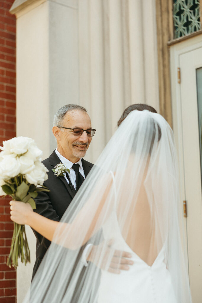 Father of the bride sharing a first look with her daughter 