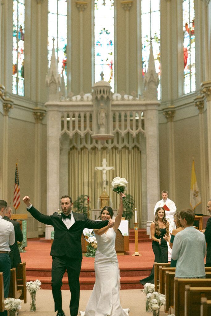 Bride and groom walking back down the aisle as husband and wife during their Grand Rapids wedding ceremony