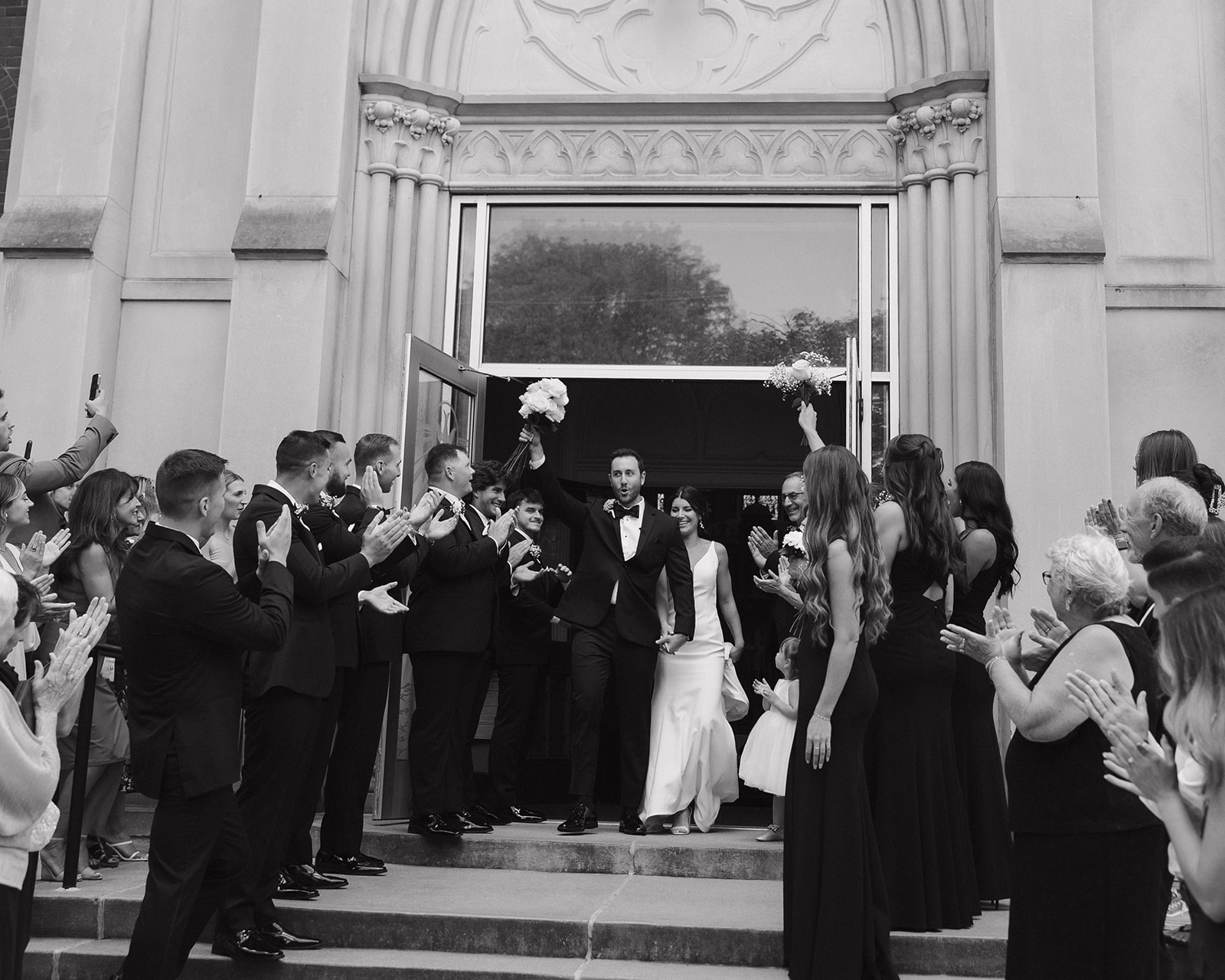 Black and white photo of a bride and grooms Grand Rapids wedding ceremony exit