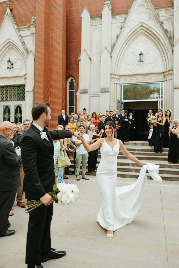 Bride and groom dancing during their Grand Rapids wedding ceremony exit