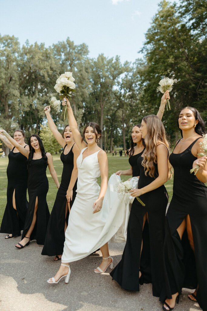 Bride and her bridesmaids walking for her Grand Rapids wedding portraits