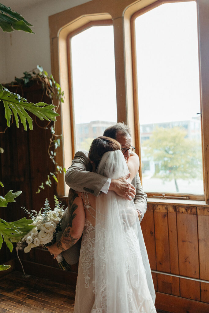 Bride and her father hugging after sharing their first looks