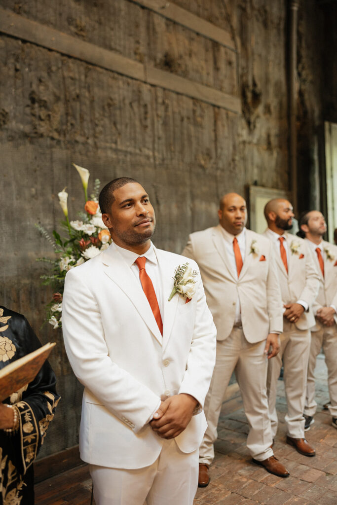 Groom seeing his bride walking the the aisle during their Jam Handy wedding ceremony in Detroit, Michigan