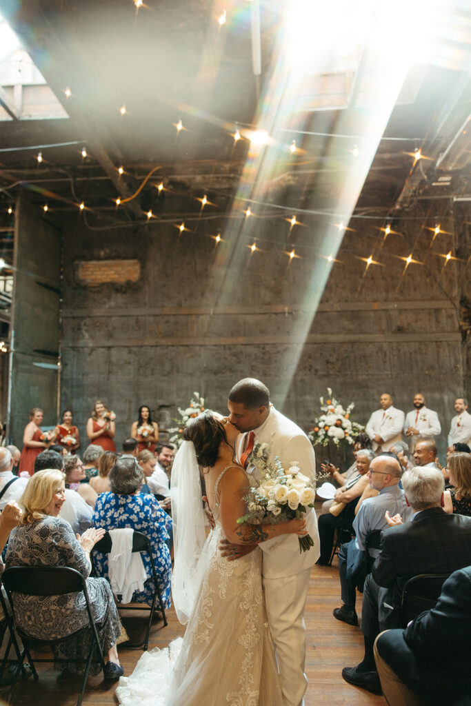 Bride and groom kissing after their Jam Handy wedding ceremony in Detroit, Michigan