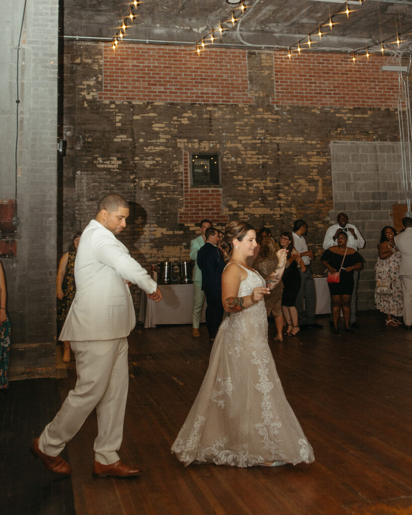 Bride and groom entering the dance floor  at Jam Handy wedding venue in Detroit, Michigan