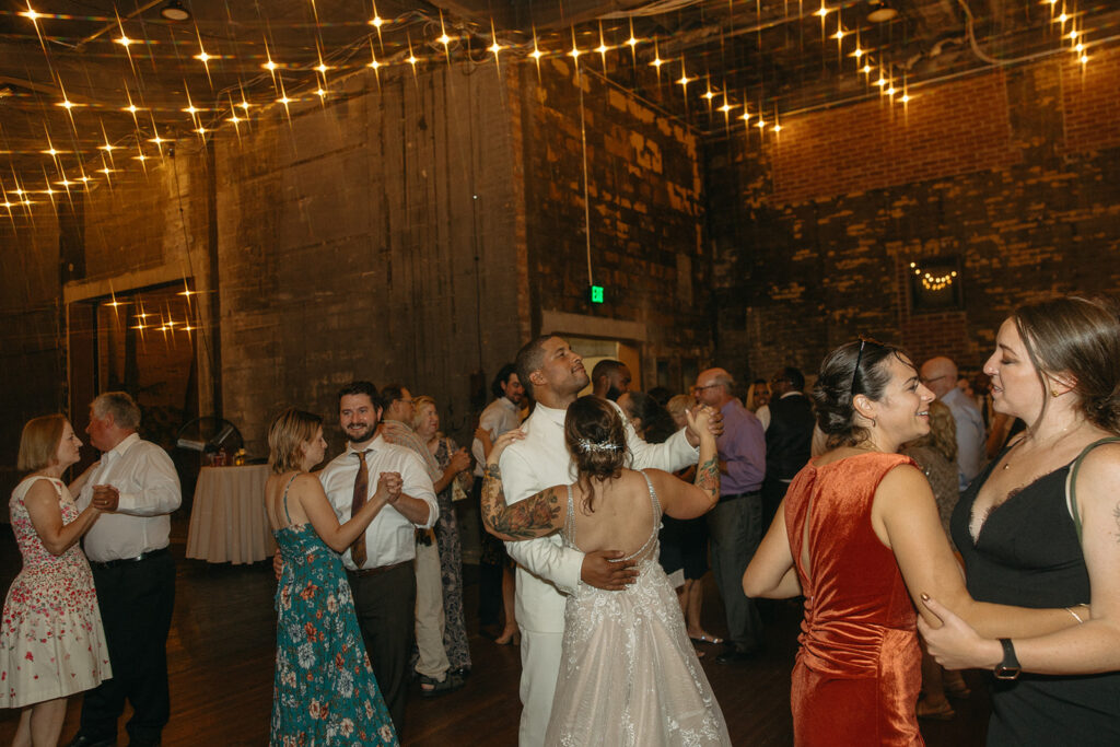 Bride and groom dancing with their guests during their Jam Handy wedding reception