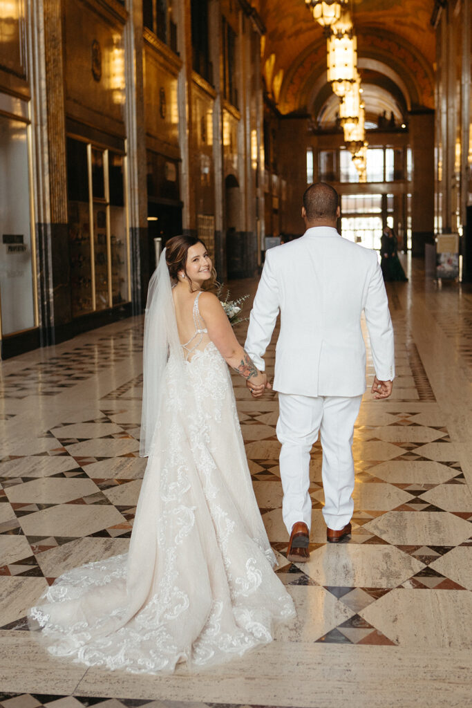 Bride and groom in the Grand Arcade of Fisher Building in Detroit, Michigan