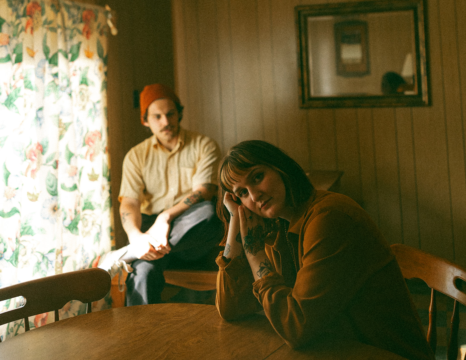 Man and woman posing for photos in their kitchen during their at-home vintage couple photoshoot in Michigan