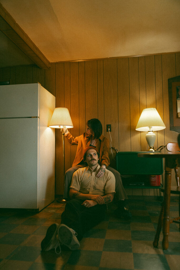 Man and woman posing in a kitchen during their at-home vintage couple photoshoot in Michigan