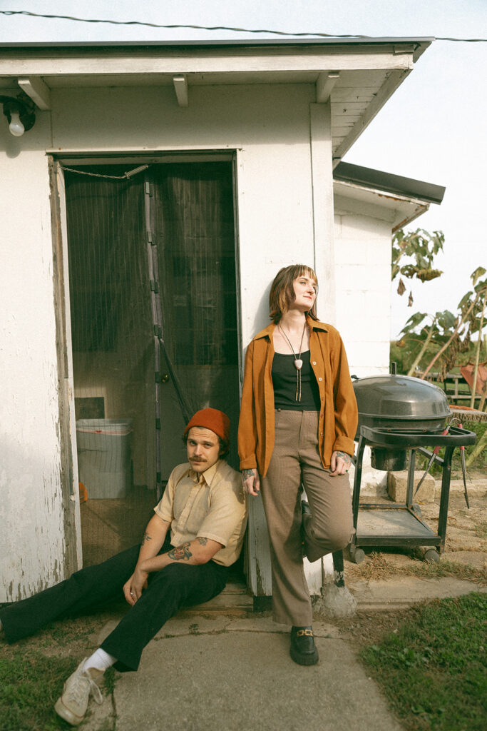 Man and woman posing outside for their at-home vintage couple photoshoot in Michigan