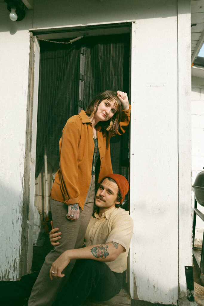 Man and woman posing outside for their at-home vintage couple photoshoot in Michigan