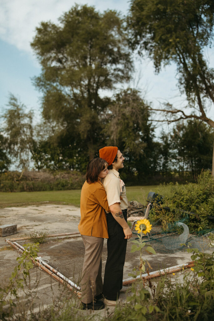 Woman hugging her partner from behind during their outdoor couples shoot in Michigan