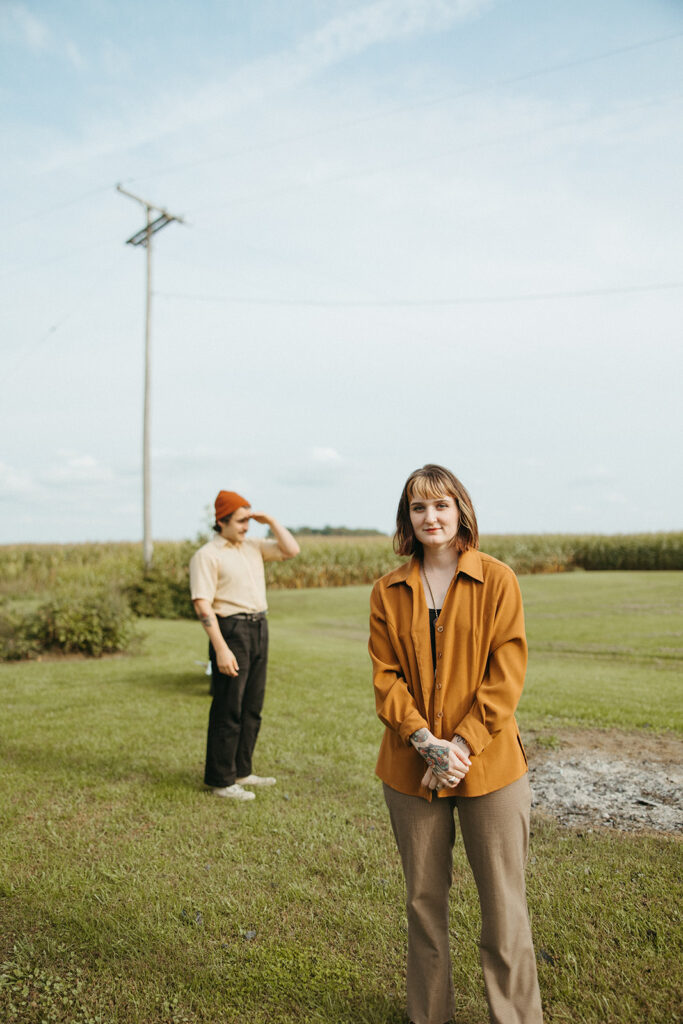 Man and woman posing outside for their Michigan couples photos