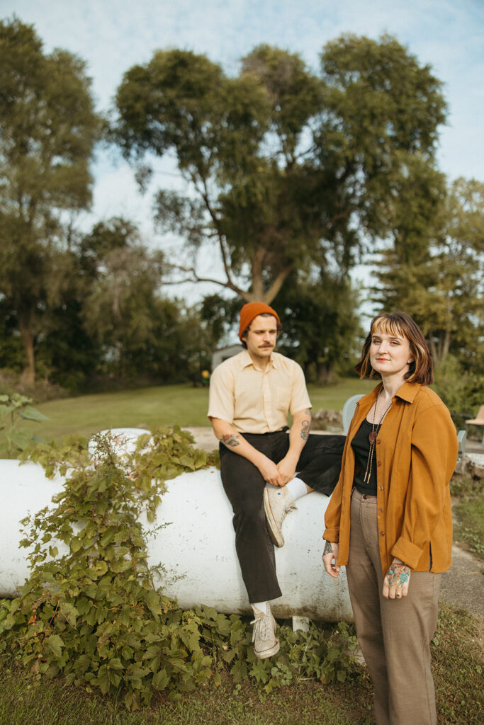 Man and woman posing outdoor with a propane tank during their at-home vintage couple photoshoot in Michigan