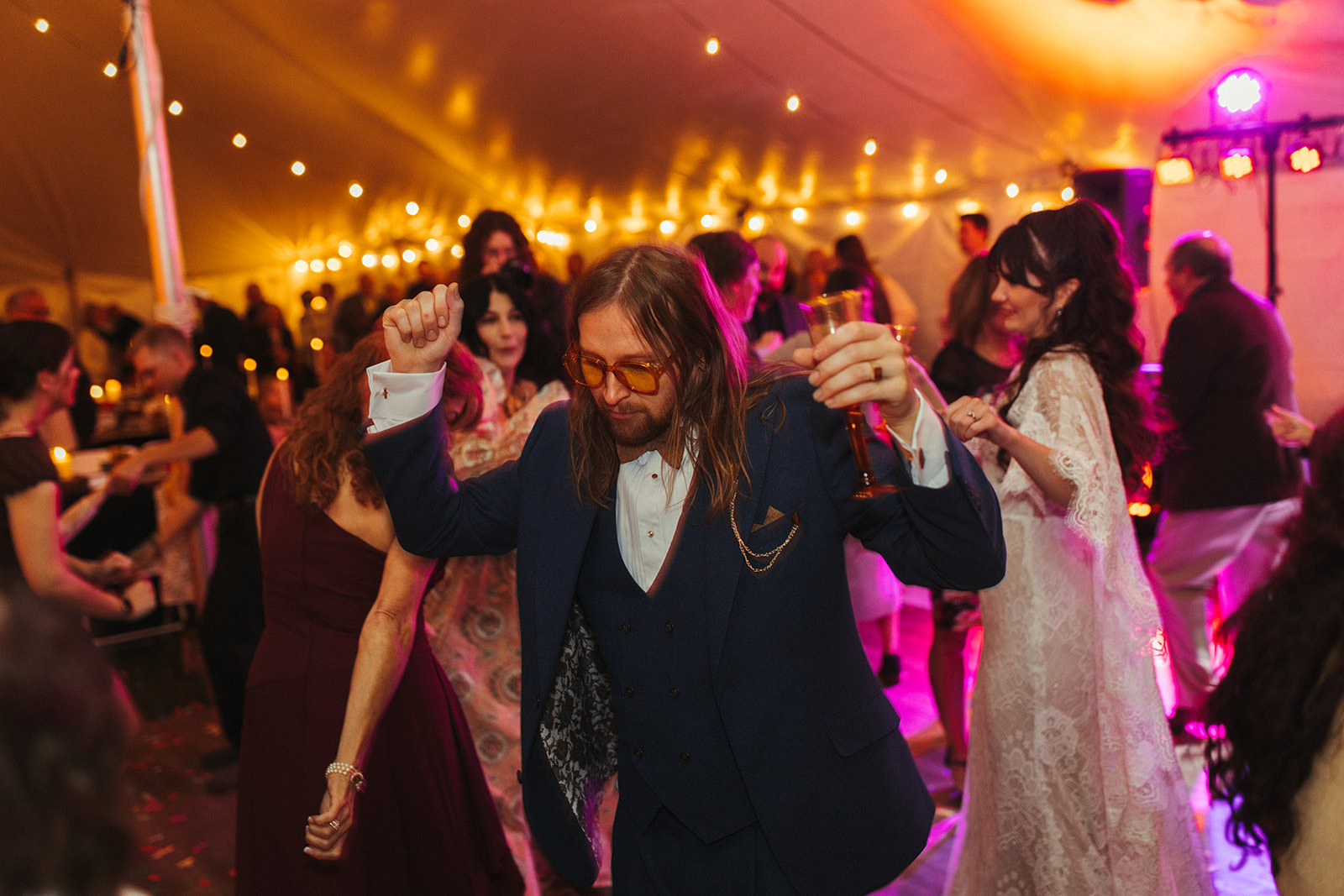 Bride and groom dancing with their guests during their outdoor backyard wedding reception in Michigan