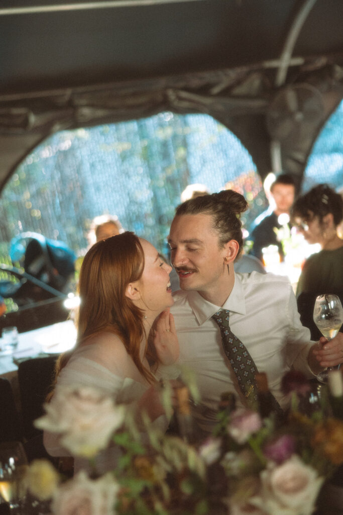 Bride and groom smiling and laughing together during their Detroit wedding reception at Mabel Grey