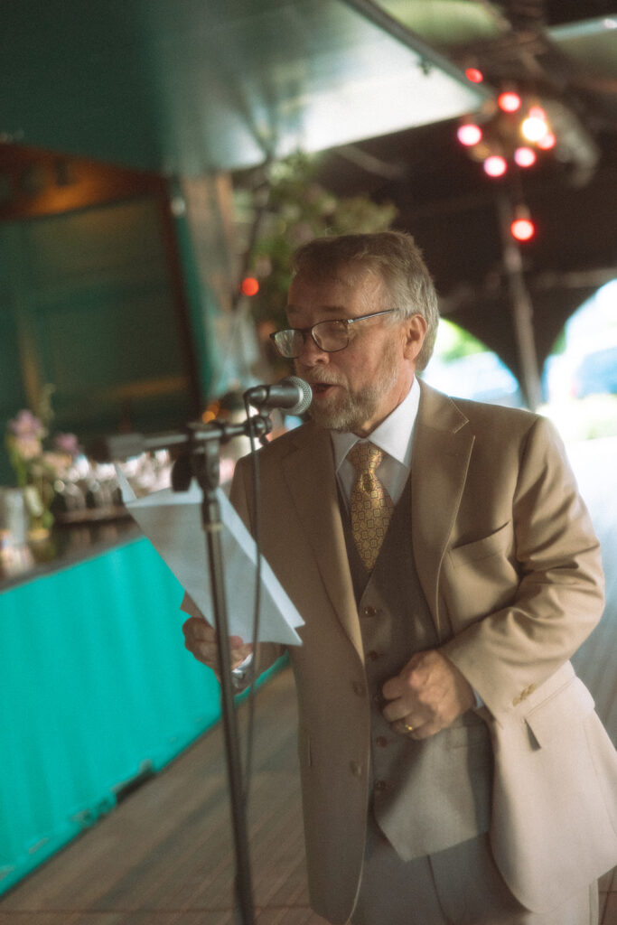 Brides father giving a speech at the wedding reception