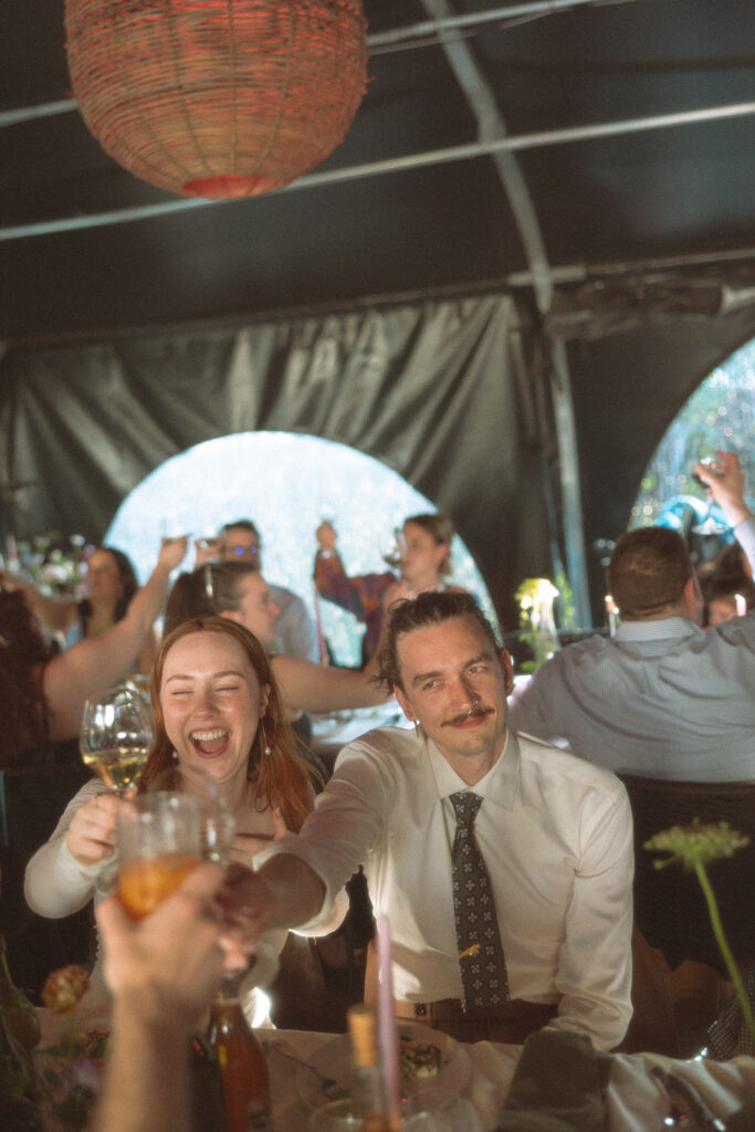 Bride and groom toasting during their Detroit wedding reception at Mabel Grey