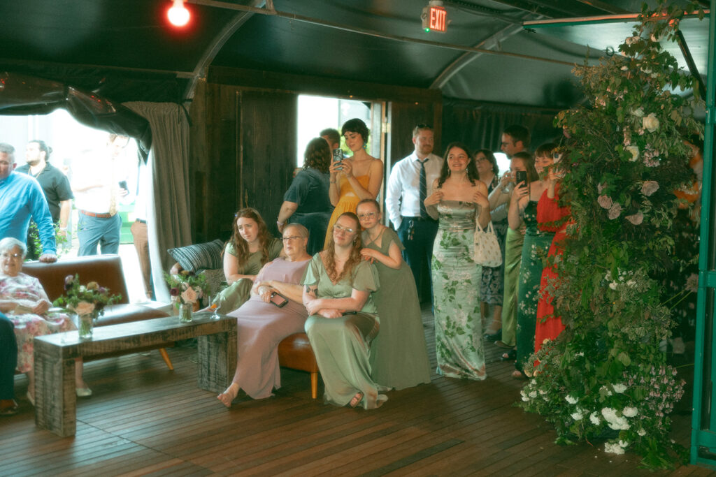 Wedding guests watching as the bride and groom share their first dance