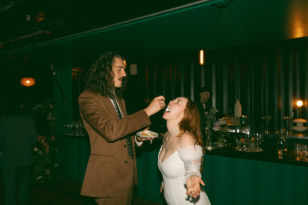 Groom feeding his bride pie from Sister Pie during their Mabel Grey Detroit wedding reception