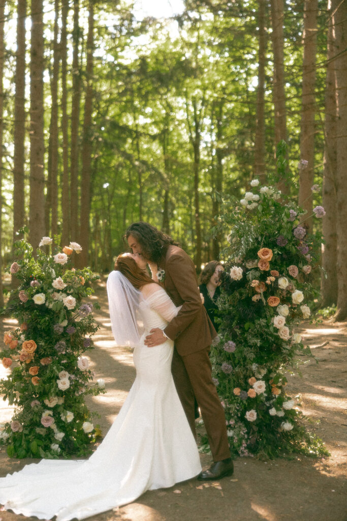 Bride and groom kissing during their Stony Creek Metropark wedding ceremony in Detroit, Michigan